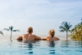 Couple in infinity pool looking at horizon Royalty Free Stock Photo