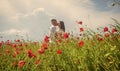 Lovely couple kissing in the poppy field, love Royalty Free Stock Photo