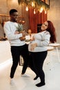 Lovely couple at the kitchen, smiling, gorgeous woman with attractive man cooking Christmas dinner, spend winter Royalty Free Stock Photo