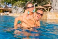 Couple laughing and having fun in swimming pool Royalty Free Stock Photo