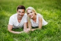 The lovely couple in love sitting on green grass. Royalty Free Stock Photo