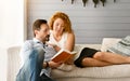 Lovely couple reading book together at home Royalty Free Stock Photo