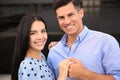 Lovely couple showing beautiful engagement ring outdoors