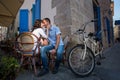 Lovely couple sitting in sidewalk cafe near their tandem bicycle Royalty Free Stock Photo