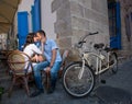 Lovely couple sitting in sidewalk cafe near their tandem bicycle Royalty Free Stock Photo