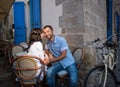 Lovely couple sitting in sidewalk cafe near their tandem bicycle Royalty Free Stock Photo
