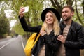 Lovely couple with smartphone taking selfie on spring day