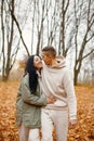 Lovely couple standing in autumn forest and kissing Royalty Free Stock Photo