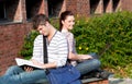 Lovely couple of students sitting back to back Royalty Free Stock Photo