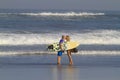 Lovely couple with surfboards on beach. Royalty Free Stock Photo