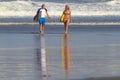 Lovely couple with surfboards on beach. Royalty Free Stock Photo