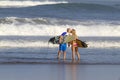 Lovely couple with surfboards on beach. Royalty Free Stock Photo