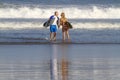 Lovely couple with surfboards on beach. Royalty Free Stock Photo