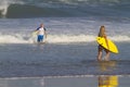 Lovely couple with surfboards on beach. Royalty Free Stock Photo