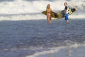 Lovely couple with surfboards on beach. Royalty Free Stock Photo