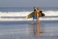 Lovely couple with surfboards on beach. Royalty Free Stock Photo