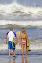 Lovely couple with surfboards on beach. Royalty Free Stock Photo