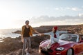 Lovely couple traveling by car near the ocean Royalty Free Stock Photo