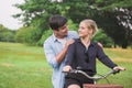 Happy young couple riding a bicycle in the park