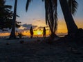 Couple watching sunset with palm trees in Candaraman Island in Balabac Philippines Royalty Free Stock Photo