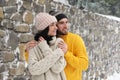 Couple wearing warm sweaters and hats outdoors on snowy day. Winter season Royalty Free Stock Photo