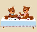 Lovely cute little teddies are sitting at a long table and eating wooden berries with wooden spoons with milk