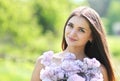 Lovely cute smiling girl with a bouquet of lilacs