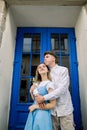 Lovely date on the street. Happy hipster young couple, handsome man with his attractive girlfriend in blue dress Royalty Free Stock Photo