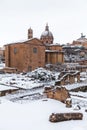 A lovely day of snow in Rome, Italy, 26th February 2018: a beautiful view of snowy Roman Forums and Church of the Saints Luca and Royalty Free Stock Photo