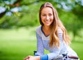 Lovely day to be outdoors. Portrait of a young woman cycling in the park. Royalty Free Stock Photo