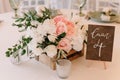 Lovely details decoration of a beautiful and stylish wedding: flowers in a wooden box and number of a table Royalty Free Stock Photo