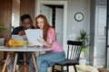 Lovely diverse man and woman check documents