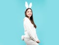 Lovely Easter woman in bunny rabbit costume. Girl wearing bunny ears on easter holidays.