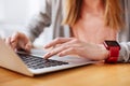 Lovely engaged woman typing on her computer