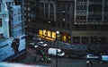 A lovely evening street view with traffic, pedestrians and illuminated vitrines Royalty Free Stock Photo