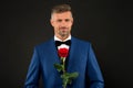 Lovely face of male. groom in tuxedo with rose. during wedding ceremony. groom in wedding jacket. bowtie is principal