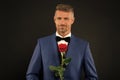 Lovely face of male. groom in tuxedo with rose. during wedding ceremony. groom in wedding jacket. bowtie is principal