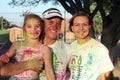 Lovely family covered in powder paint posing