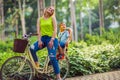 lovely family having quality time outdoors- mother and son riding a bicycle together in park Happy family.. Royalty Free Stock Photo