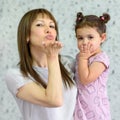 Mom and daughter smile looking at camera blowing kiss, small kid spend time with young grandma, communicate via internet Royalty Free Stock Photo