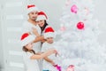 The lovely family spending their good time as a family on a day of christmas by decorating the huge Christmas tree Royalty Free Stock Photo