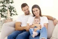 Lovely family with their baby girls relaxing on sofa at home Royalty Free Stock Photo