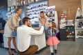 Lovely family of young couple and toddler girl in a home decor shop together, faher high fiving his daughter, family feeling