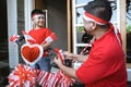 Father decorating bicycle with indonesia flag with his son