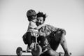 Lovely father teaching son riding bike. Happy dad helping excited son to ride a bicycle. Young smiling boy wearing Royalty Free Stock Photo