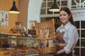 Lovely female baker working at her cafe