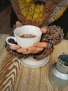 Lovely female hands holding a white Cup of hot coffee. A girl in a Cozy warm knitted sweater holding a Cup of hot coffee Royalty Free Stock Photo