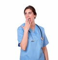 Lovely female nurse standing looking surprised