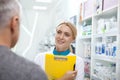 Lovely female pharmacist helping her client Royalty Free Stock Photo