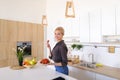 Lovely female posing and smiling at camera with plate of ripe st Royalty Free Stock Photo